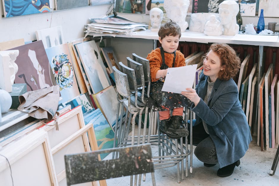 Art teacher guiding a young child during a painting lesson in a colorful art studio.