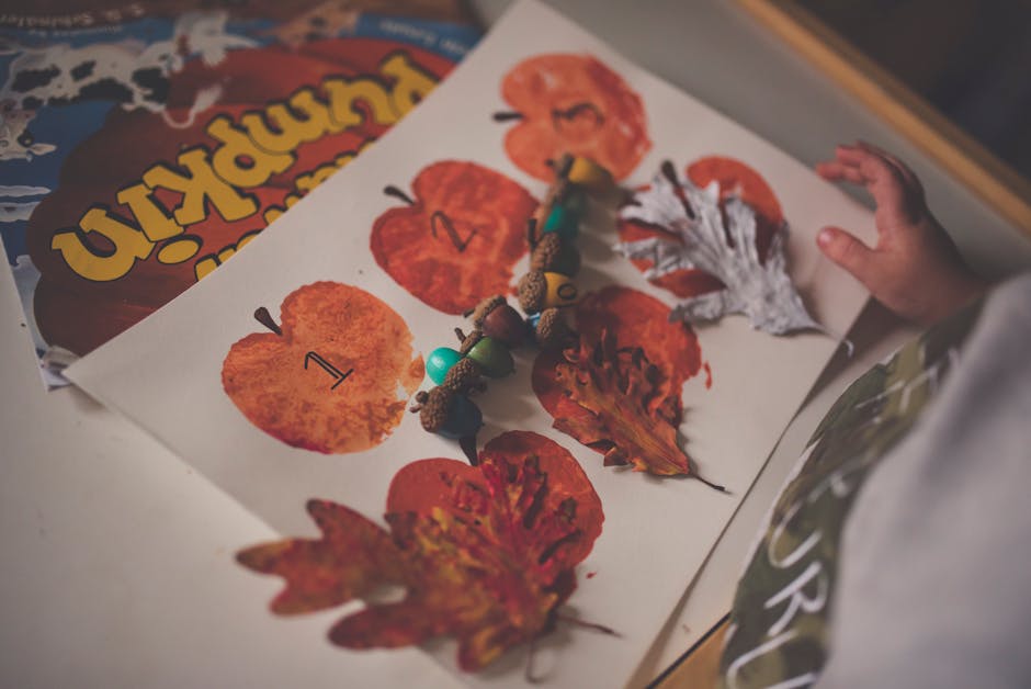 Fall-themed kids' craft featuring painted apples, pumpkins, and leaves.